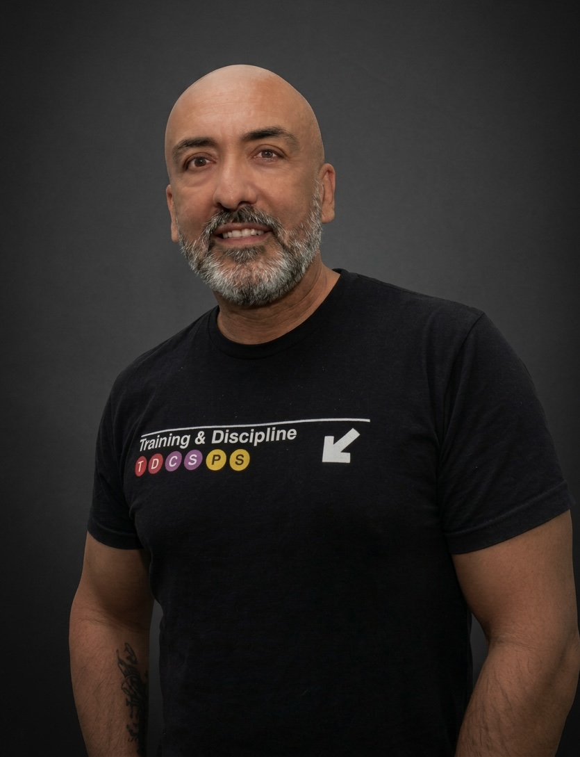 Brian Guzman, owner of Training & Discipline studio in Palm Springs, wearing Training & Discipline shirt